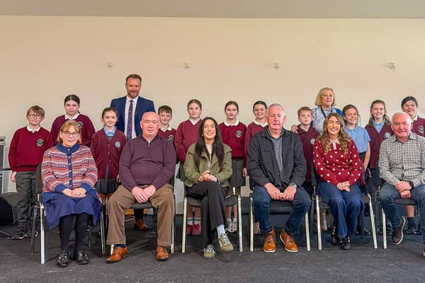 Political representatives pictures with teachers and pupils of St Brigid's and Knockloughrim Primary Schools.