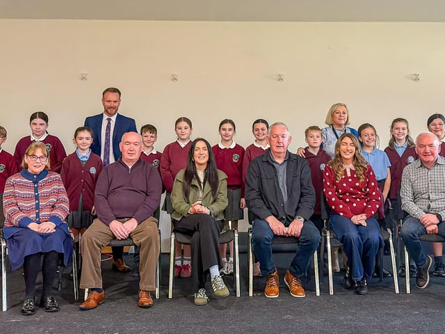 Political representatives pictures with teachers and pupils of St Brigid's and Knockloughrim Primary Schools.