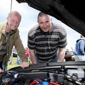 Ronnie McBride and John Cochrane look at an engine during the Ford Fair at the Dunluce Centre in 2009