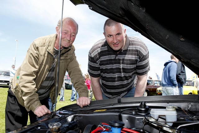 Ronnie McBride and John Cochrane look at an engine during the Ford Fair at the Dunluce Centre in 2009