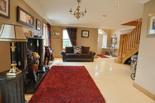 The entrance hall / living space features a fireplace with gas fire and antique-style radiator.
