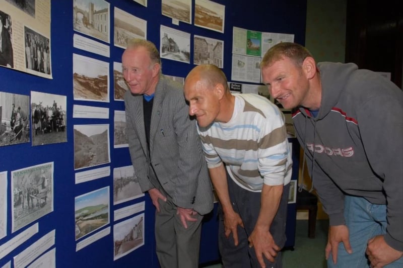 John McNeill, Cahal McAuley and Martin McCormick look at some of the old photographs on display at the Antrim Coast Lions exhibition in the Londonderry Arms Hotel in 2009.