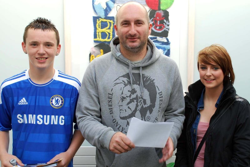 Corey McLoughlin, Mr Smyth and Clare Beagan pictured at Newtownabbey Community High School on GCSE results day 2011. INNT 35-714-JN