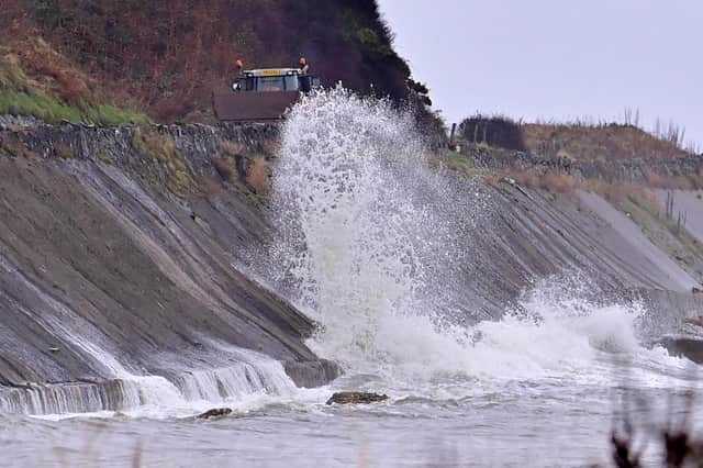 Waves crash against the Coast Road near Glenarm on Monday.