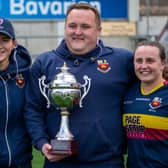 Proud coaching team - Shannon Buller, Charlie Farrell and Jemma Farrell – display the Suzanne Fleming Cup.