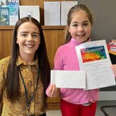 Sarah Thompson, aged 7, from Portadown, Co Armagh, who is heading to Croke Park in Dublin for a prizegiving ceremony after winning an All Ireland Credit Union Art competition. Here she is pictured with a representative of Portadown Credit Union.