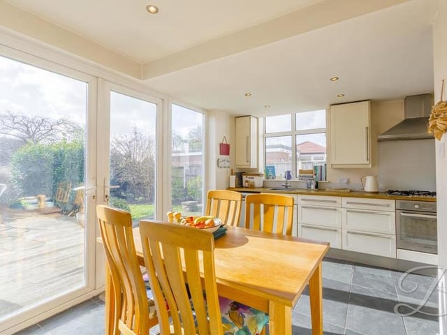 The kitchen/diner is so big that there is room to set up this lovely dining area, which comes with a view. The double doors lead out to the garden.