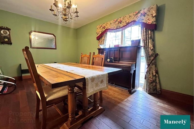 Formal dining room with solid wooden floor.