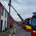 Firefighters at the scene of the house fire at Watson Street in Portadown. Picture: NIFRS