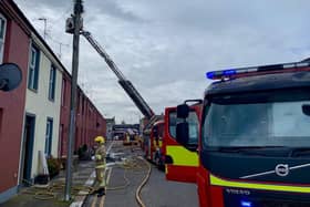 Firefighters at the scene of the house fire at Watson Street in Portadown. Picture: NIFRS