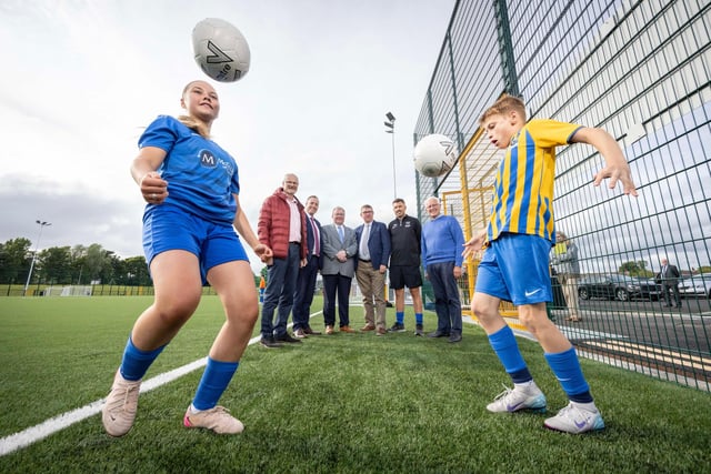Councillor Tim Mitchell, Councillor Alan Givan and Mark Watson, Head of PE at Laurelhill Community College alongside school children