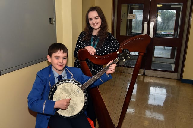 Visitors to the St John the Baptist's College open day were entertained by pupil Alex Prentice on his banjo. Also included is Music teacher Miss Margarte O'Hagan. PT03-201.