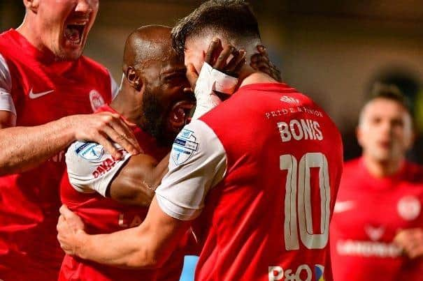 Players celebrate with Lee Bonis during the match with Ballymena United. (Pic by Pacemaker).