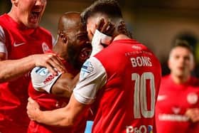 Players celebrate with Lee Bonis during the match with Ballymena United. (Pic by Pacemaker).