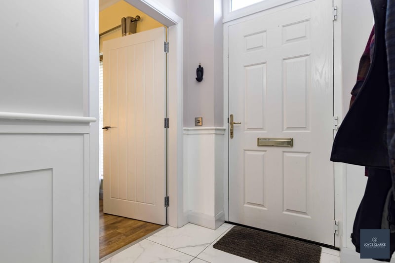 The entrance hall has a composite front door door with glazed panel above. There is tiled flooring and feature panelling to the walls in the hallway and stairs.