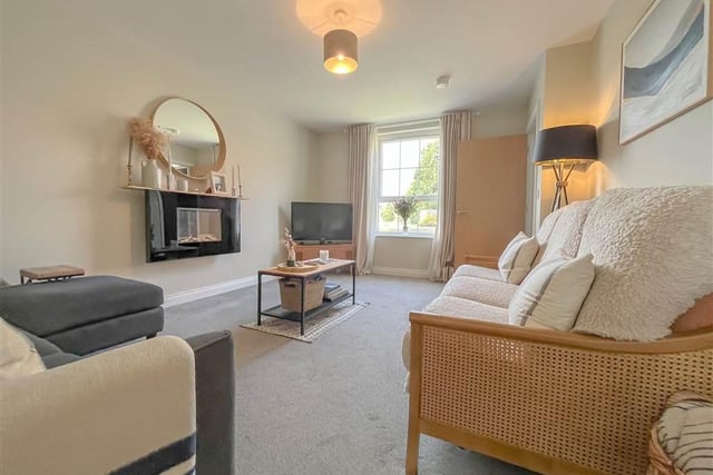 Lounge with feature wall-mounted electric fire.