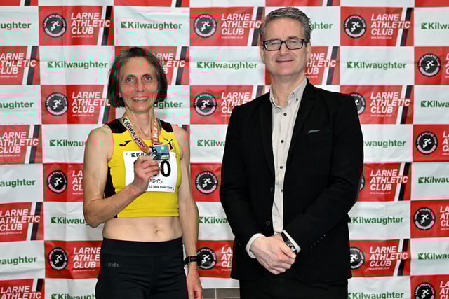 Gladys Ganiel from North Belfast Harriers who won the women’s race at the 2025 Kilwaughter Minerals Larne 10 Mile Race, is pictured being congratulated by Gary Wilmot, MD of Kilwaughter Minerals (now part of Saint-Gobain).