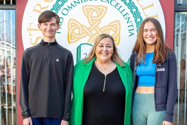 Top Boy, Niall Mitchell and Top Girl, Meabh McCann of St Ronan's College in Lurgan who achieved 10 x A*A in their GCSEs. They are pictures with Principal Mrs Fiona Kane.