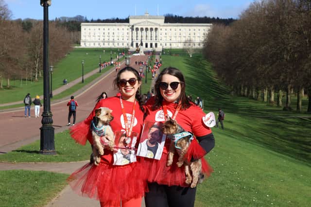 Gaby and her sister, Janine, at this year’s Red Dress Fun Run with their dogs, one of whom won the Best Dressed Dog competition.