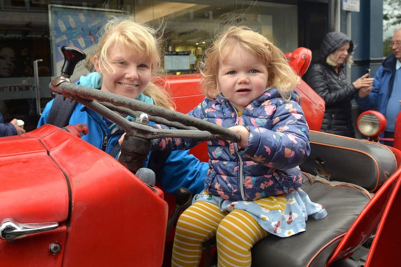 Sophia Stewart (2) enjoying playing on a vintage tractor at Country Comes To Town watched by mum, Lynn. PT38-218.