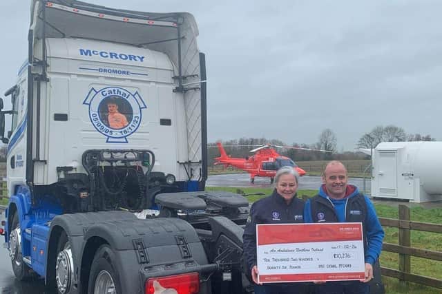 Pauline and Peter McCrory with the cheque for Air Ambulance NI.