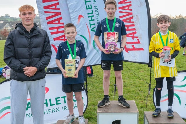 (L-R): Callum Baird, Athletics NI and Flahavan’s League Ambassador, Isaac Mooney from Our Lady of Lourdes (2nd), Hugo Lowry from Stranmillis Primary School (1st), and Eimhin Bourke from Stranmillis Primary School (3rd) at the third round of the 2024-2025 Flahavan’s Athletics NI Primary School Cross Country League at Sixmile Water Park.