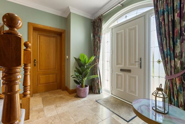 Composite door to front with double glazed side windows and fan light above.