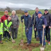 David Huey alongside pupils from St Olcan’s Primary School, Armoy WI and locals planting trees in Limepark in Armoy.