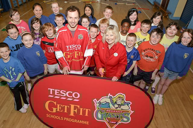 Colin Shields, captain of the Belfast Giants ice hockey team, and Ann Broome, Tecso community champions, pictured in 2010 with pupils from Lisburn Central Primary School, as part of a Giants/Tesco campaign to help children keep fit.