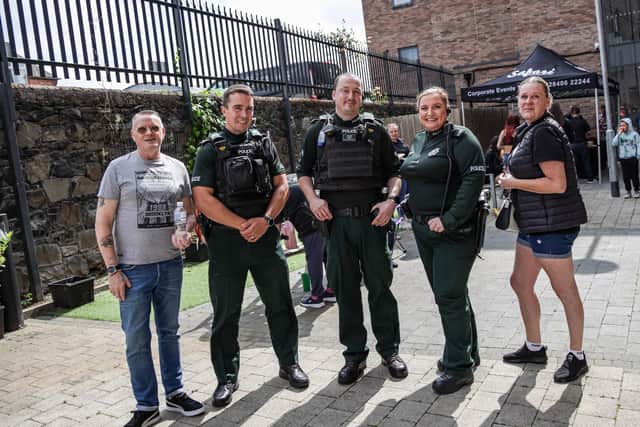 Michael Lyness and friend Holly with some of the Neighbourhood Policing Team. Pic credit: Clanmil Housing Association