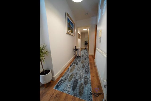 Entrance hallway with laminate wood flooring.