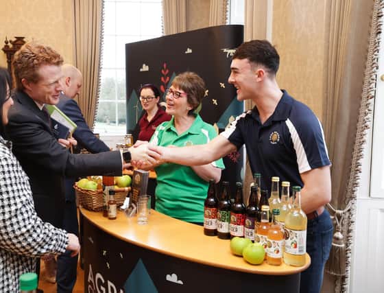 Catherine and Peter McKeever from Long Meadow Cider share their apple juice with Joe Kennedy III, US Special Investment Envoy to Northern Ireland.