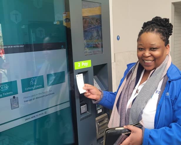 Passenger Debra Leso was the first passenger to purchase her ticket from the new self-serve ticket vending machine at the newly-opened York Street station. Picture: Translink
