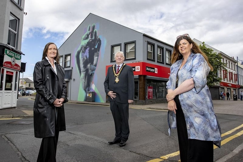 Department for Communities Officer Rhonda Williamson, Mayor of Causeway Coast and Glens Councillor Steven Callaghan and local artist Michelle McGarvey as they admire Coleraine’s town centre artworks.