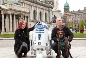 Victoria Arundell and Denis Rush from Temple Props in Templepatrick with R2D2 (and Charlie the dog) outside Belfast City Hall as the Star Wars character was officially launched before Star Wars Day, May the Fourth. Picture: Into Film’s ScreenWorks