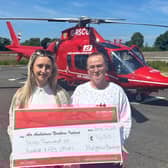 Amy Mulgrew and Lisa Gray from Mulgrew Haulage presented a cheque for £7,650 to Air Ambulance NI. The money was raised by a team from the company who took part in the Belfast Marathon. Pic credit: Air Ambulance NI