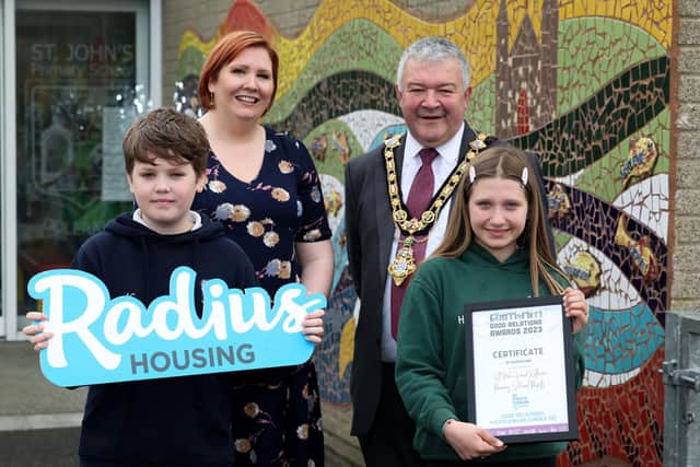 Alfie from Killowen PS and Hannah from St John's PS, with Lisa Mooney, Radius Housing, and Councillor Ivor Wallace, Mayor of Causeway Coast and Glens, celebrating their Good Relations Award.