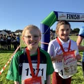 Rosie O’Boyle in 2nd place, Saidhbhin McMullan in 1st place and Grace Heaney in 3rd place at the first round of the 2023-2023 Flahavan’s Athletics NI Primary School Cross Country League. Credit Morrow Communications