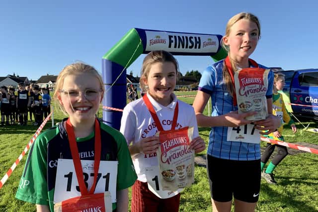 Rosie O’Boyle in 2nd place, Saidhbhin McMullan in 1st place and Grace Heaney in 3rd place at the first round of the 2023-2023 Flahavan’s Athletics NI Primary School Cross Country League. Credit Morrow Communications