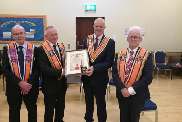 Pictured from left are Ivan Kelly Past County Grand Master, Samuel Calvin receiving his Past County Grand Master Certificate from James Evans County Grand Master and Hugh Stewart, Past County Grand Master. Credit: Submitted