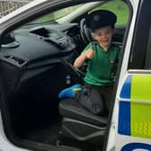 Quick thinking Harry gives a thumbs up from a police car. Credit: PSNI
