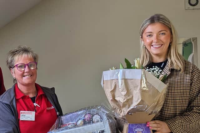 Irene Hunter is presented with her hamper and flowers by Claire Murphy from Henderson Group who thanked her for all she does with charity partner, Cancer Fund for Children, plus many other local charities and organisations.