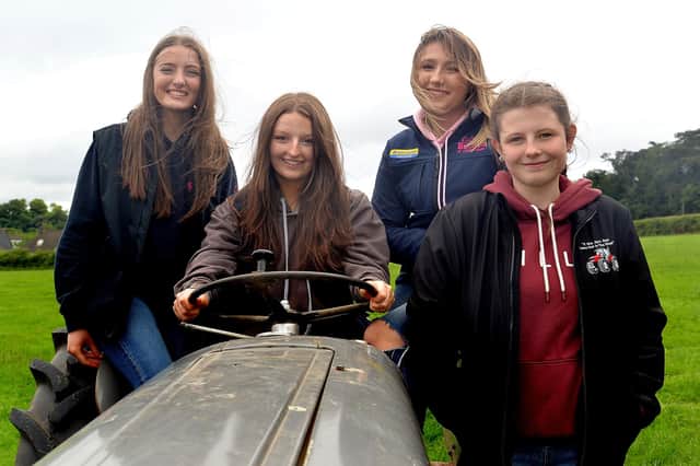 Admiring a vintage tractor at the Waringstown Vintage Cavalcade are, from left, Lucy Steele, Ellie Carson, Nicole Allen and Roslyn Savage. LM27-205. Photo by Tony Hendron.