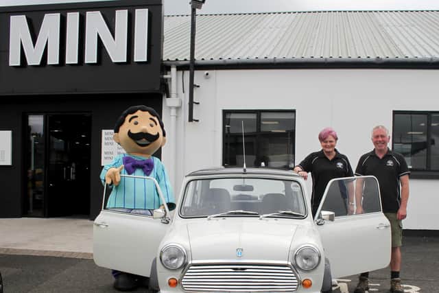 "Mr Morelli" pictured with Karen McDowell and Jonny Callan of Causeway Coast Mini Club with one of the vintage Minis. Credit Brian Moore
