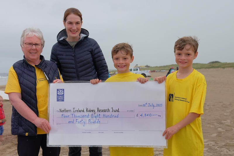 Micah and Jonah hand over a cheque to Ann McCormick NIKRF and Dr Oonagh McCloskey, renal consultant.