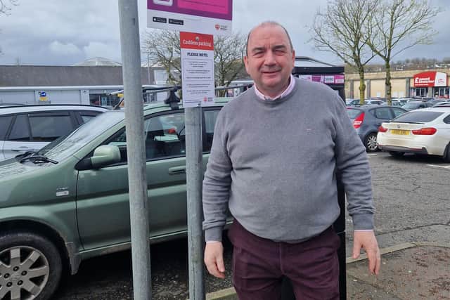 Local businessman Robert Ferguson pictured beside one of the ticket machines in Rainey Street car park, Magheraelt. Credit: National World