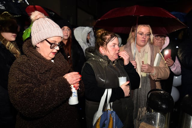 Some of the hundreds of people who braved the strong winds and driving rain to support the family of Odhran Kelly in Lurgan on Wednesday night. LM50-237.