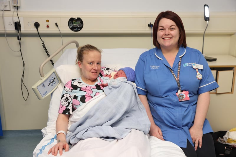 Sophie Moulds with her newborn son Alfie and midwife Christiana Jordan at the Royal Victoria Hospital, Belfast.  Alfie was born at 43 minutes past midnight on January 1, 2024.