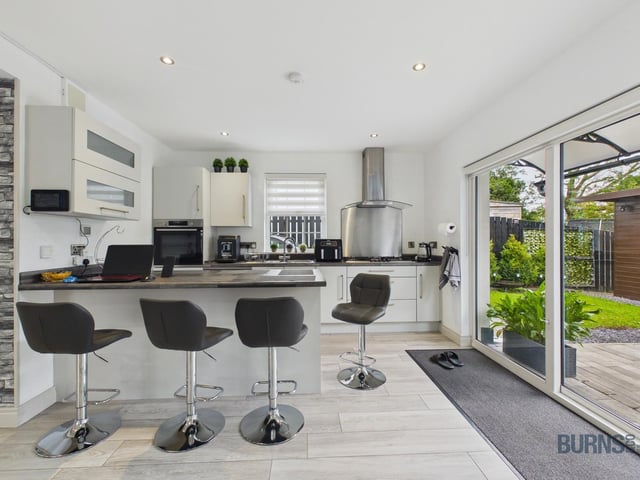 Kitchen with patio doors opening directly onto the rear garden.