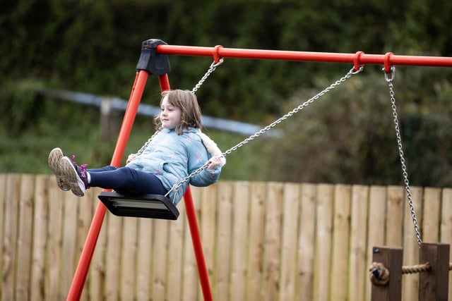 One of the children enjoying the new play equipment at Armoy Playpark.